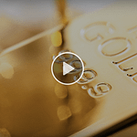 Close-up of stacked gold bar highlighted by warm reflections to convey gold’s liquidity, stability, and enduring value.